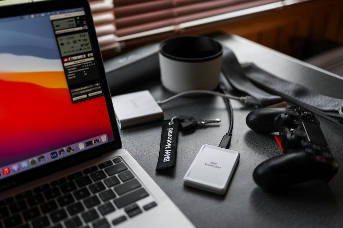 black usb flash drive beside macbook pro