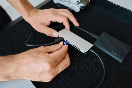 A person is using a mouse on a desk