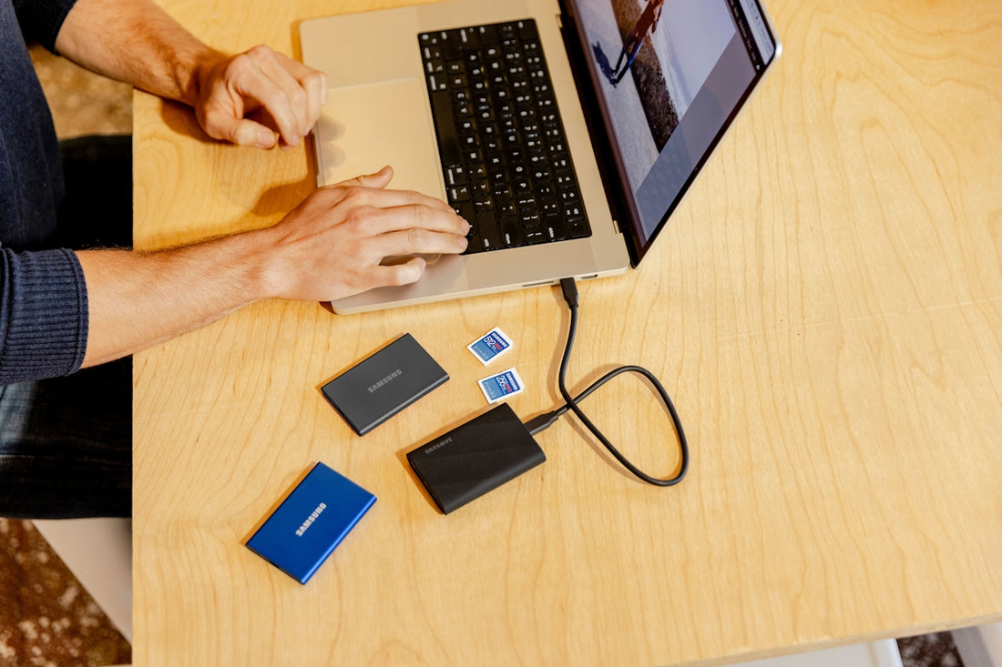A person sitting at a table working on a laptop
