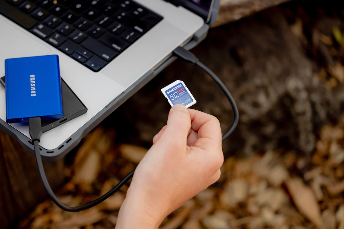 A person holding a small card near a laptop