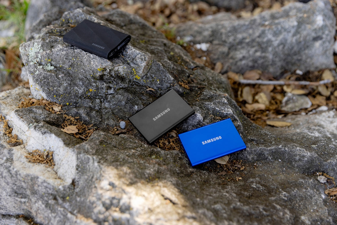 A couple of cell phones sitting on top of a rock