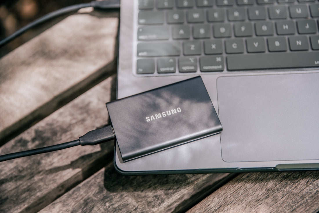 A samsung power bank sitting on top of a laptop