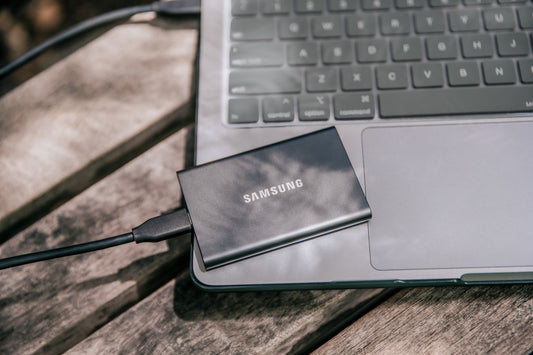 A samsung power bank sitting on top of a laptop