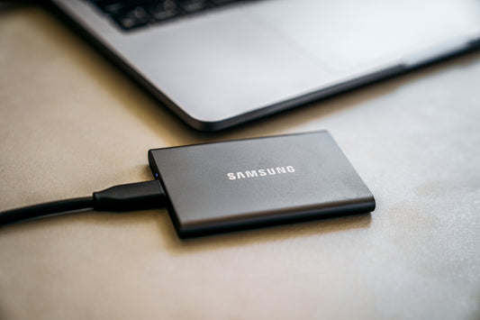 A close up of a laptop and a charger on a table