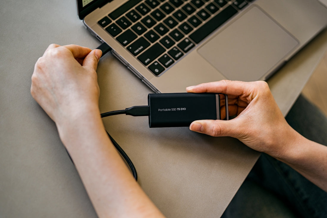 A person is using a laptop with a charger